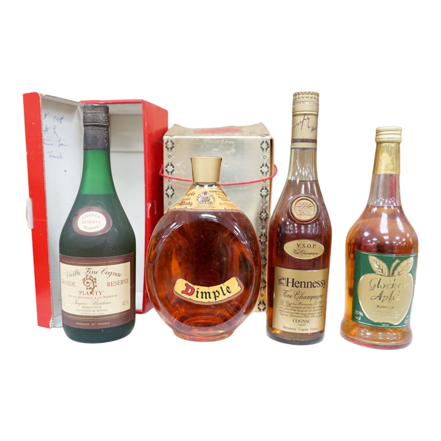 Four bottles of various alcohols comprising a bottle of 50cl Hennessey Fine Champagne Cognac, Planty Fine Cognac, Dimple Scotch Whisky and Glocken Apfel. Condition - fair, storage history unknown